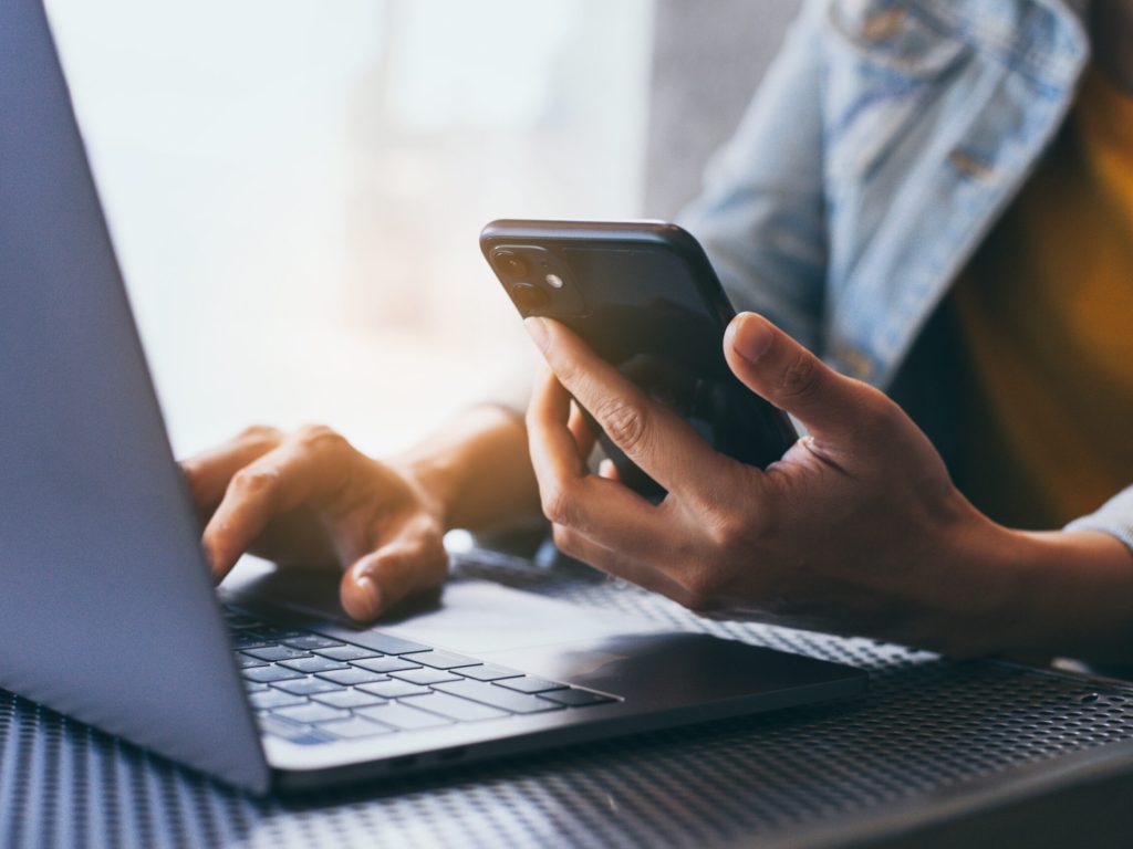 work using texting cell phone typing computer.chatting on mobile,laptop contact us at workplace Thinking investment plan Investor.searching information internet.connecting people concept